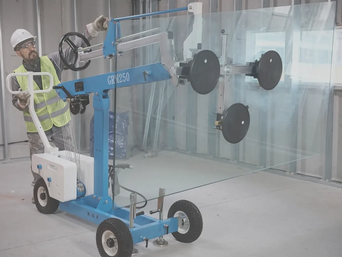Glazier operating a GRM250 vacuum glass lifter on a jobsite